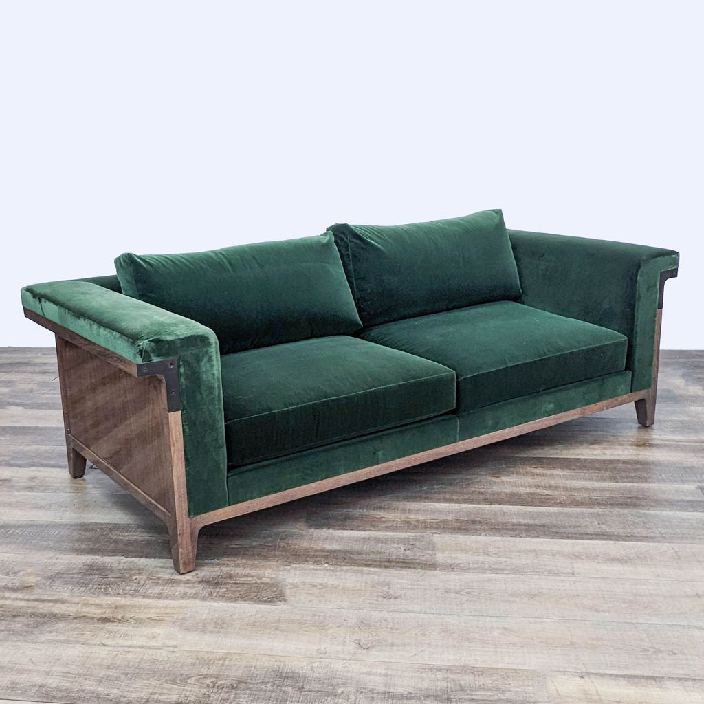 Angular perspective of Reperch 3-seat sofa in green velvet with visible wood frame and metal details.