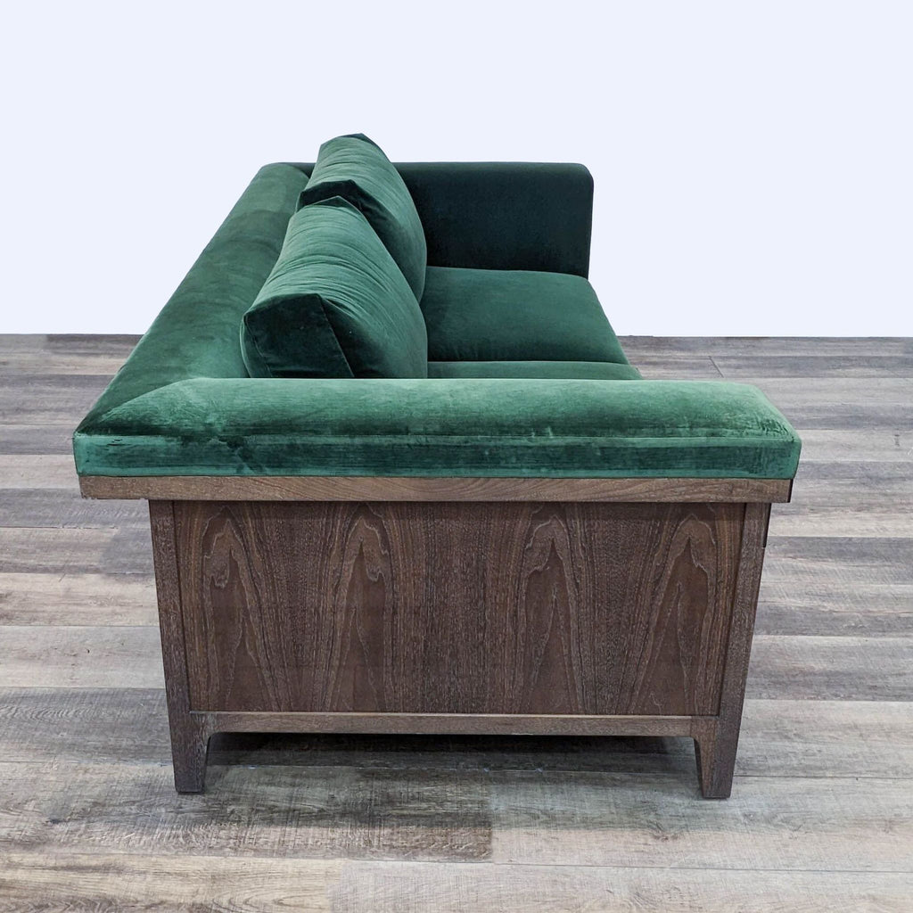 Side view of a Reperch green velvet upholstered 3-seat sofa with sturdy wood frame.