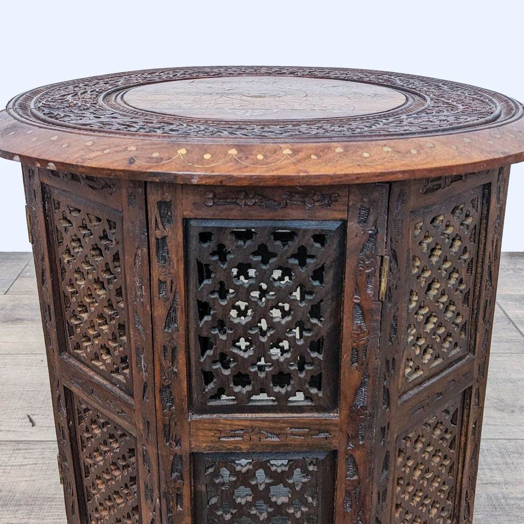2. Close-up of World Market side table showing detailed brass inlay design on wood with lattice sides.