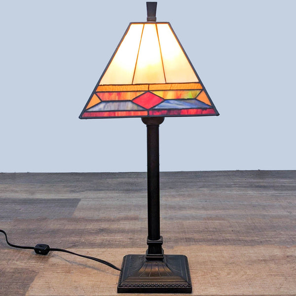 1. Tiffany-style table lamp with multicolored glass shade and dark bronze base, displayed against a grey background.