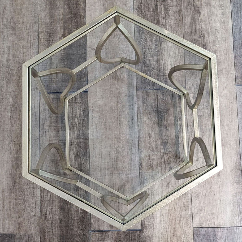 a large glass hexagon shaped mirror with a geometric design.