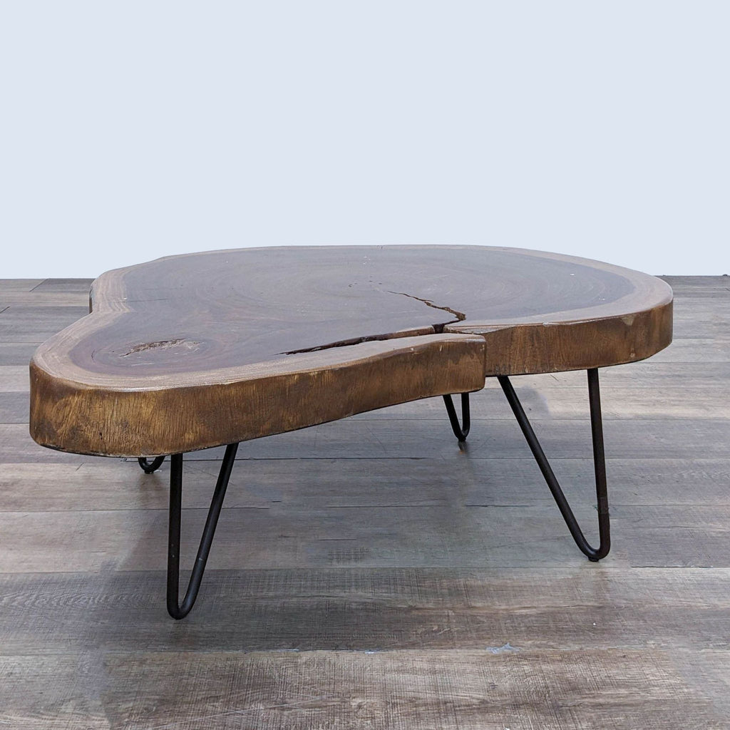 Side-angle view of a Reperch wood slab coffee table on a wooden floor.