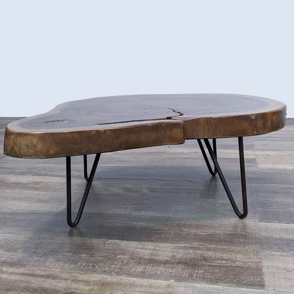 Reperch brand coffee table with a natural edge wooden top and black metal legs.