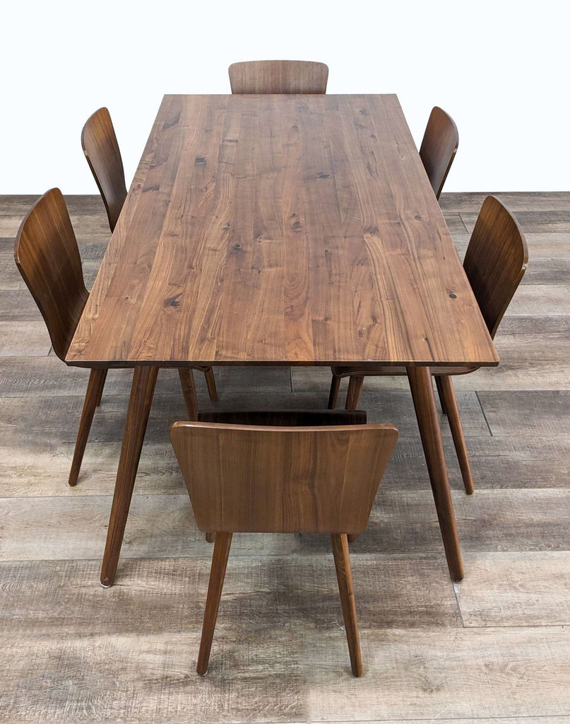 a set of six dining chairs and a table.