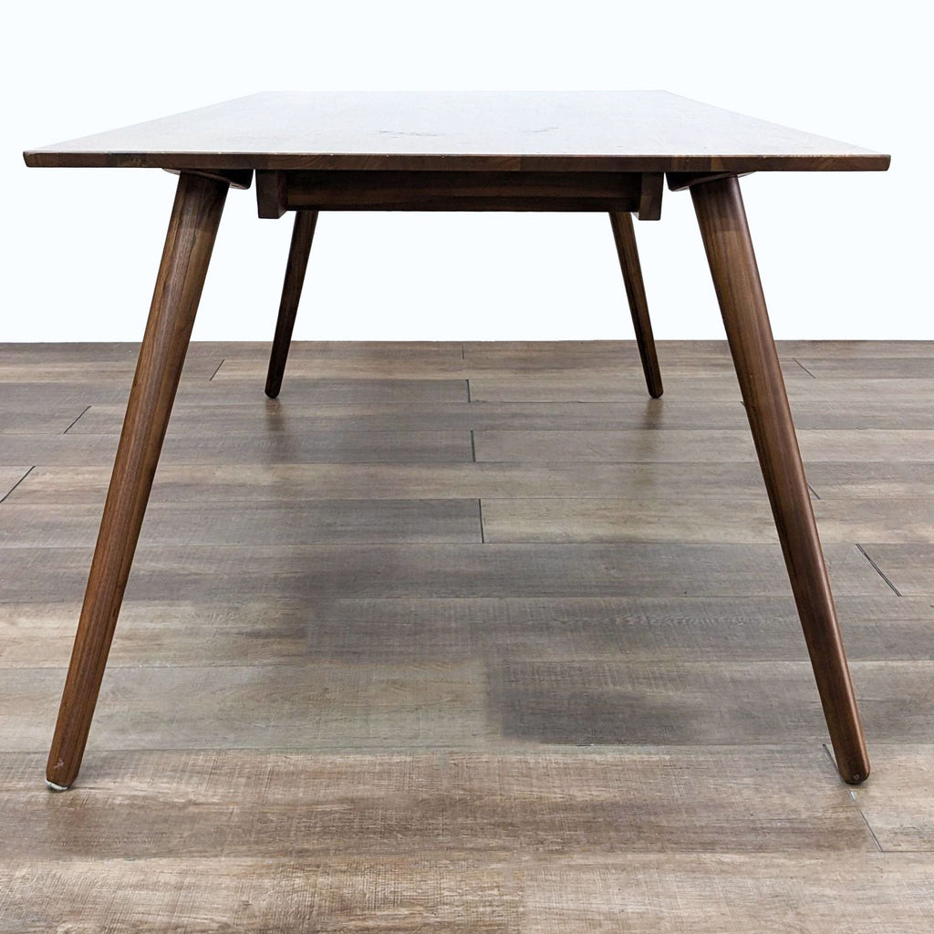 a mid century modern walnut dining table