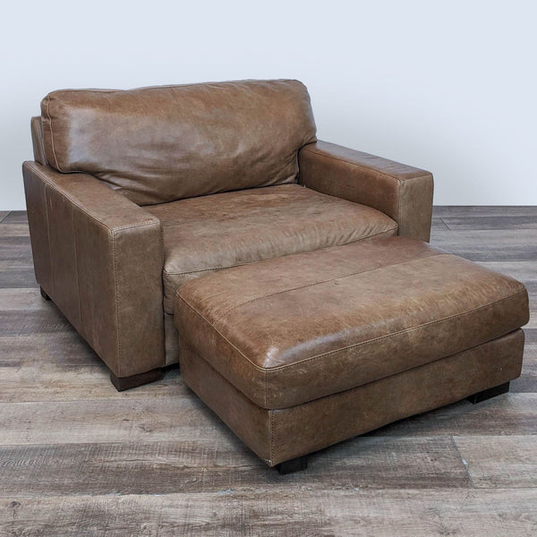 Jerome's brand plush leather lounge chair with clean lines and matching ottoman on a wooden floor.