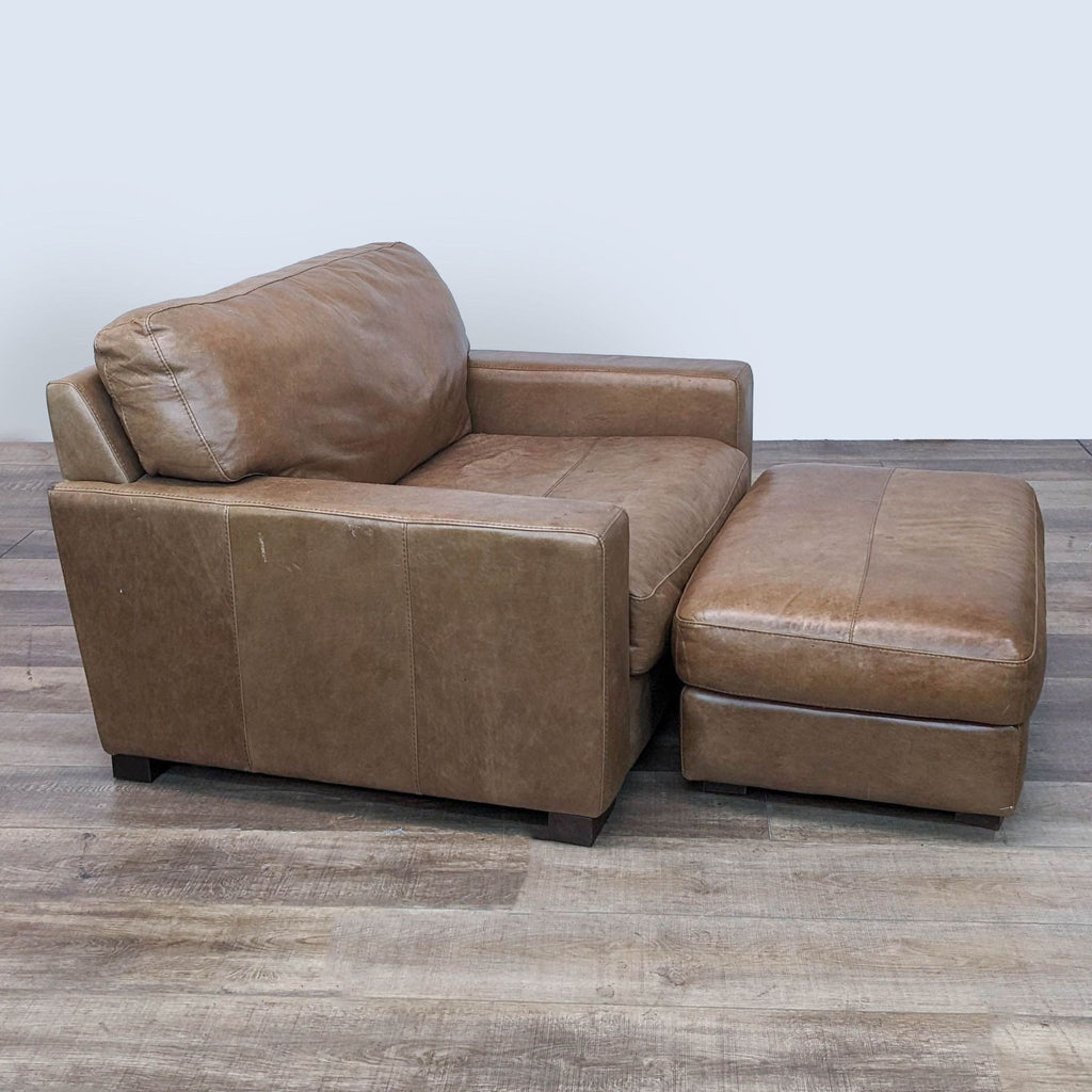 Leather lounge chair from Jerome's, shown at an angle, with ottoman, featuring clean lines and plush seating.