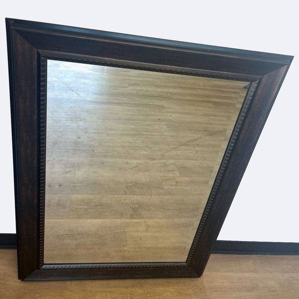 a large antique mirror with a carved wood frame.