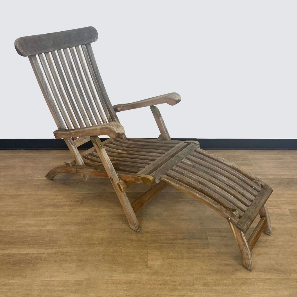 Side view of a gray teak lounge chair, featuring an adjustable backrest.  