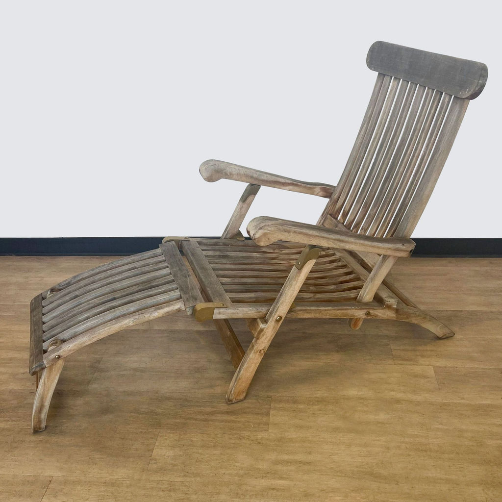 Weathered teak lounge chair with foldable design and extendable footrest.