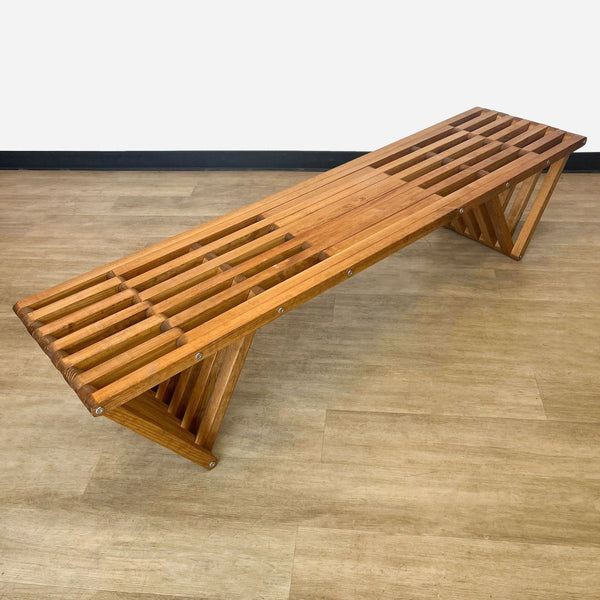 a wooden bench made from a single piece of wood.