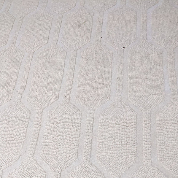 a large scale geometric pattern in a white porcelain tile.