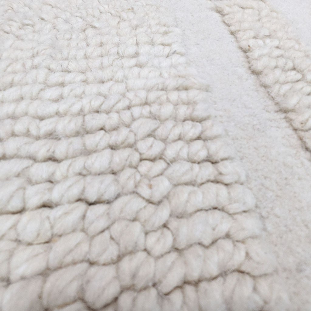a close up of a white faux fur throw.