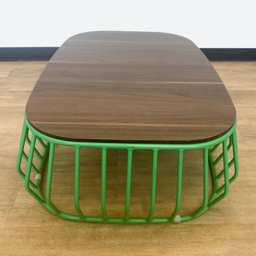 a green metal coffee table with a green metal base.
