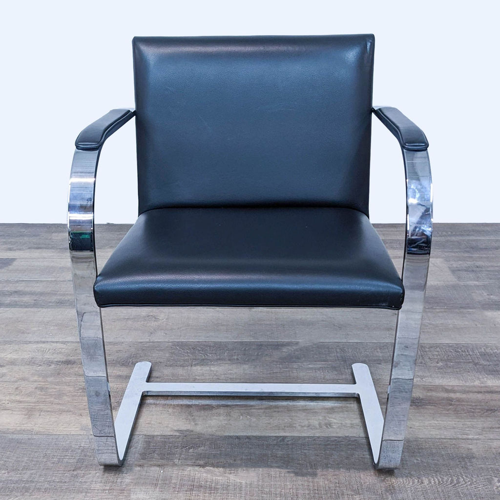 a pair of chrome and black leather swivel chairs