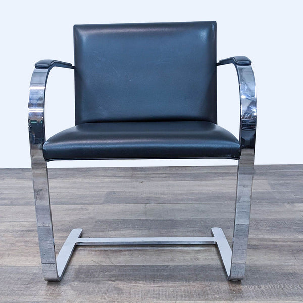 a pair of chrome and black leather lounge chairs
