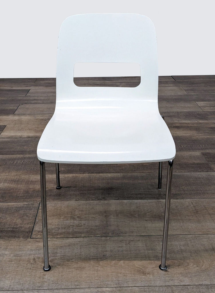 a white plastic chair with chrome legs and a white plastic seat.