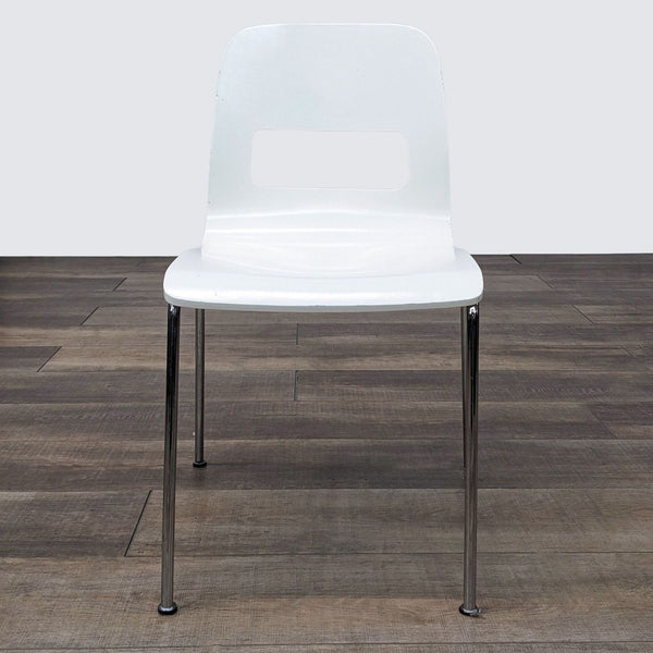a white plastic chair with chrome legs.