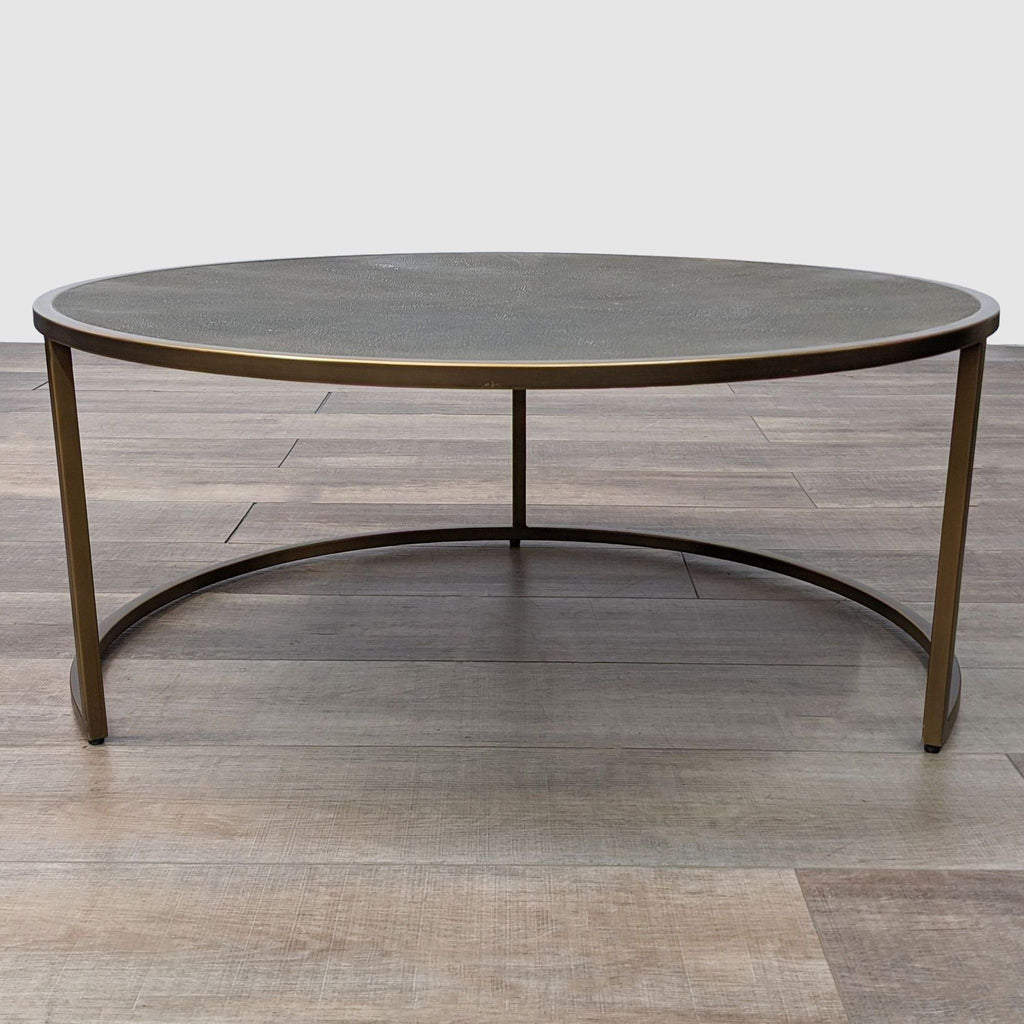 a round coffee table with a bronze top.