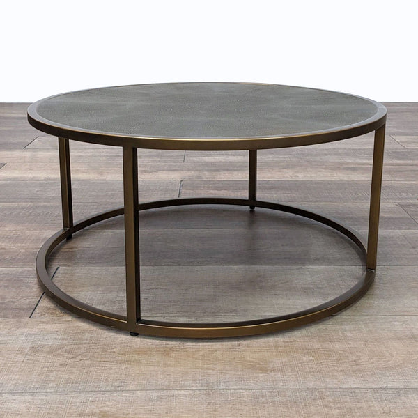 the coffee table is a round coffee table with a round metal frame and a round metal base.