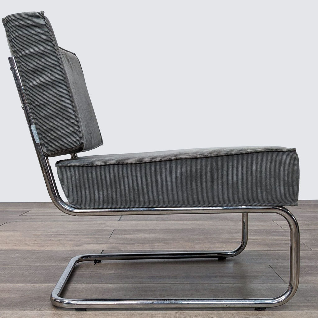 a pair of chrome and leather lounge chairs by [ unused0 ].