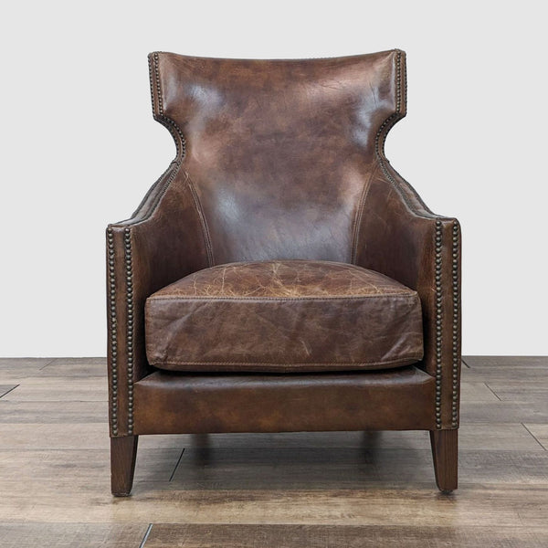 a pair of vintage leather wingback chairs.
