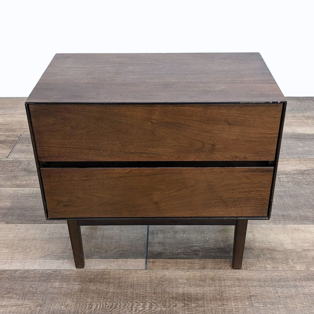 a mid century modern bedside table with two drawers.