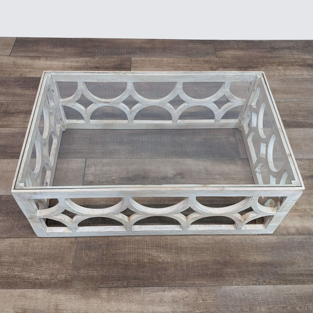 a square glass coffee table with a metal frame.