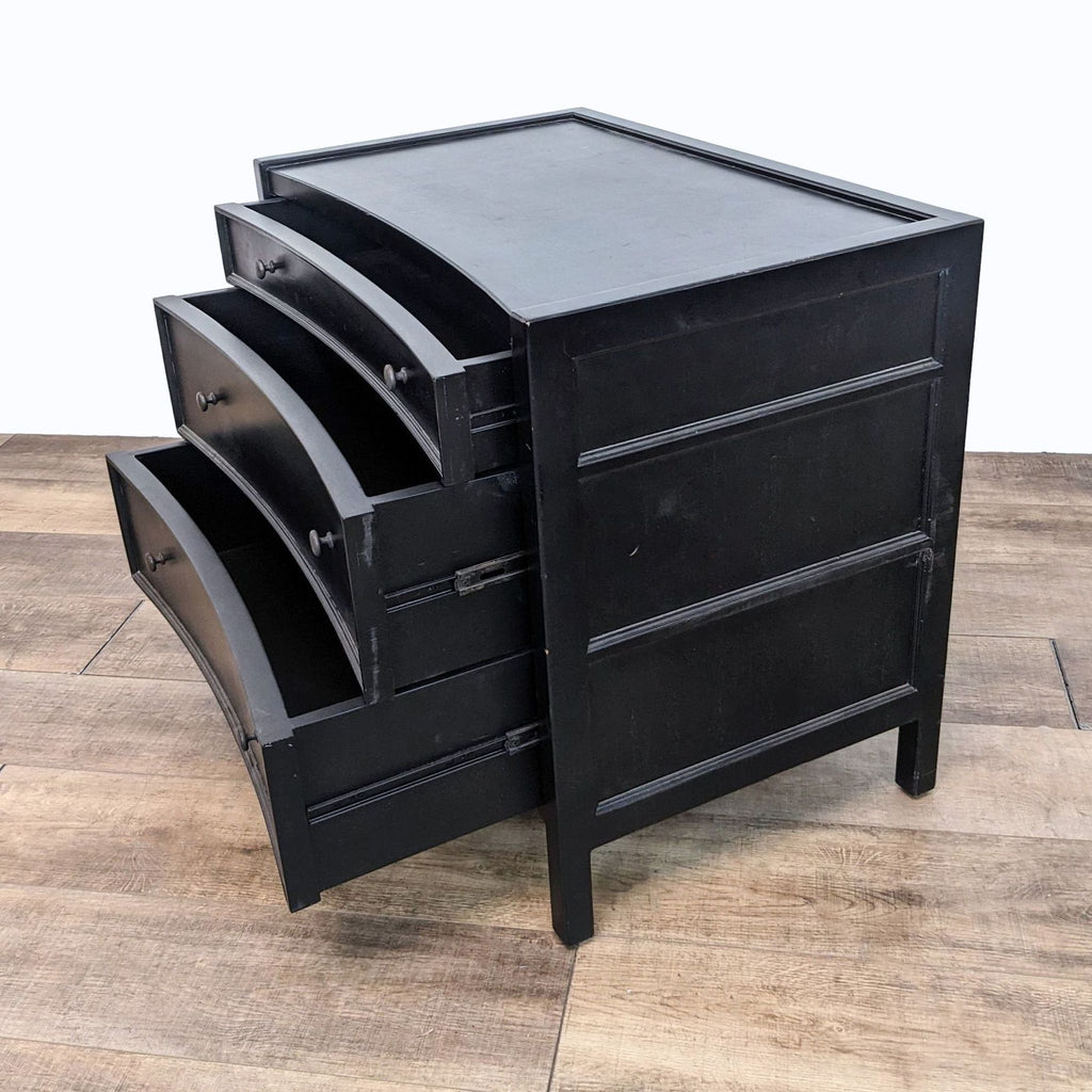a vintage black lacquer desk with three drawers.