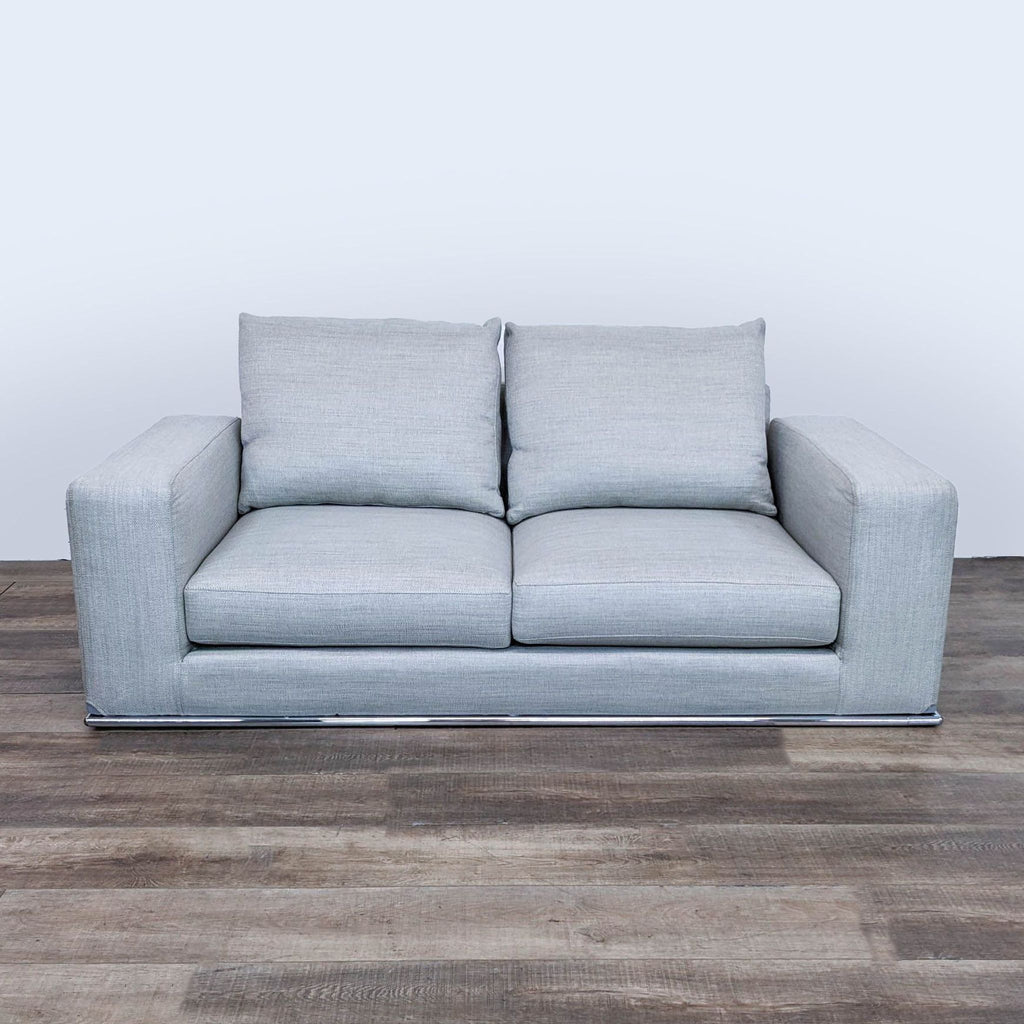 sofa in a grey color. the sofa is made of a soft fabric with a soft, comfortable
