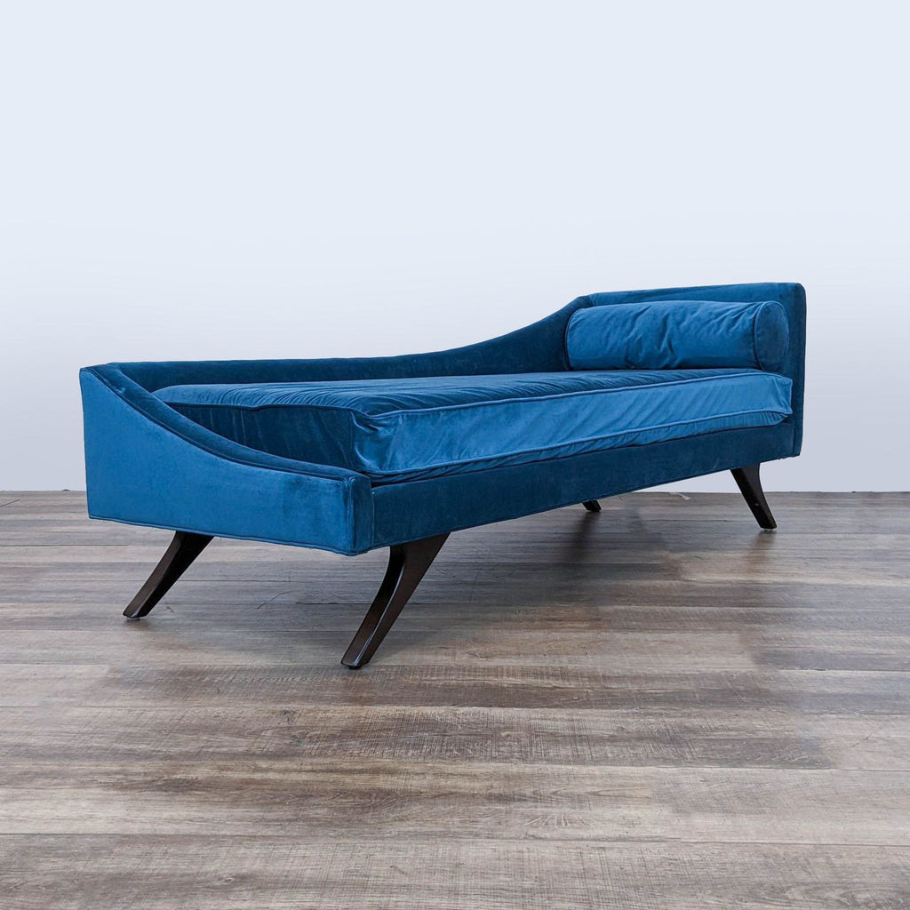 a blue velvet sofa by [ unused0 ], circa 1960.