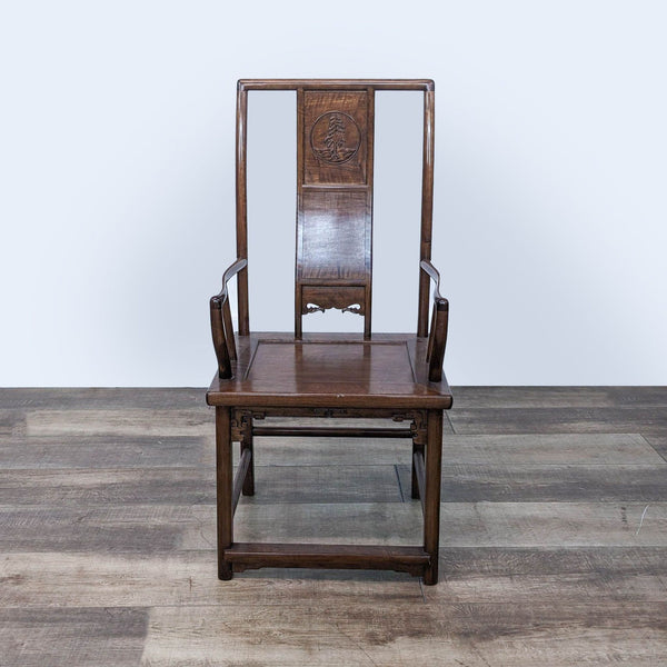a chinese style chair with a carved back