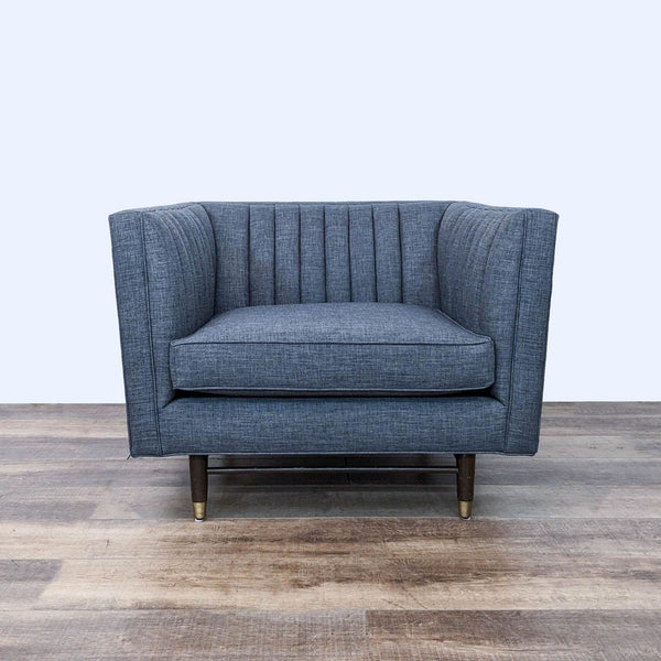 a black couch with a blue chair on it 