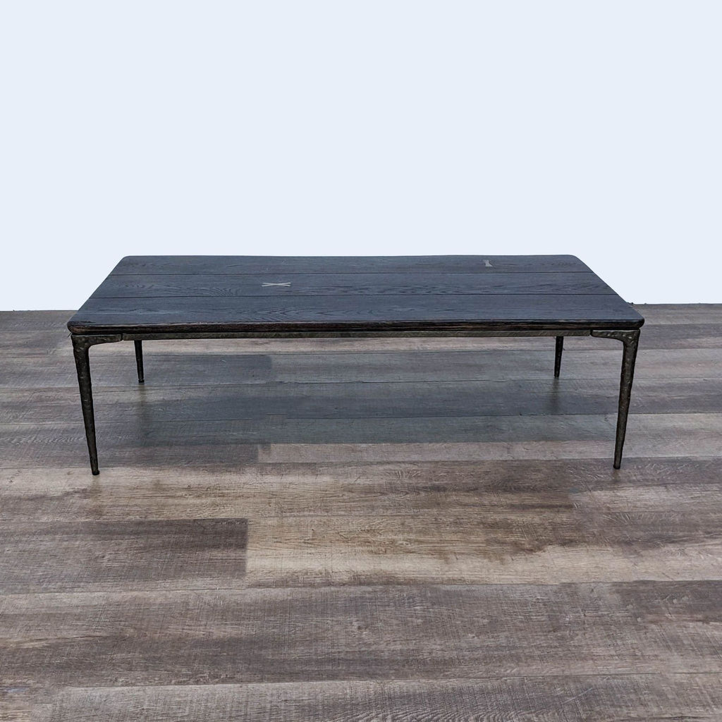 a coffee table in black iron with a white top.
