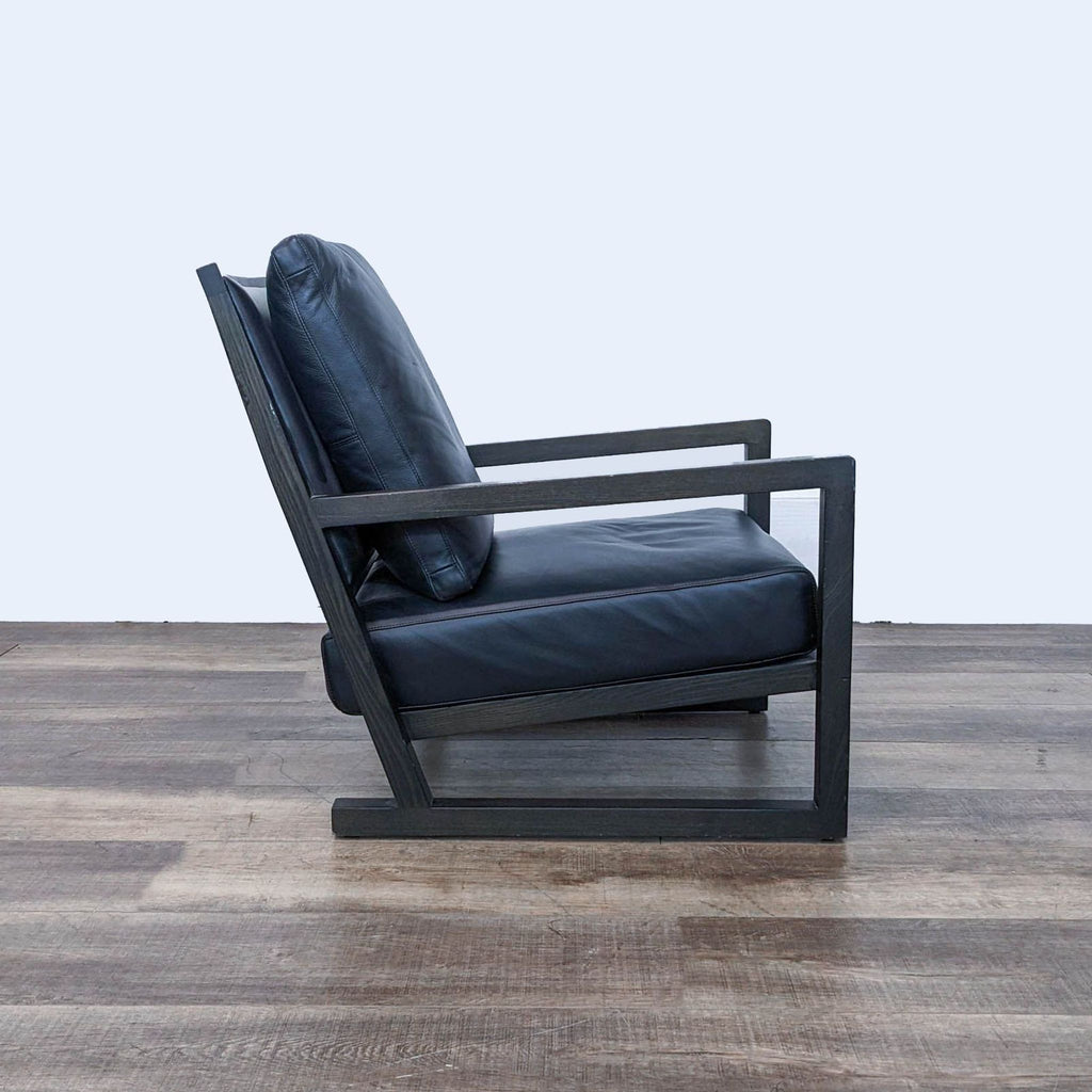 a pair of black leather lounge chairs in the style of [ unused0 ], italy, circa