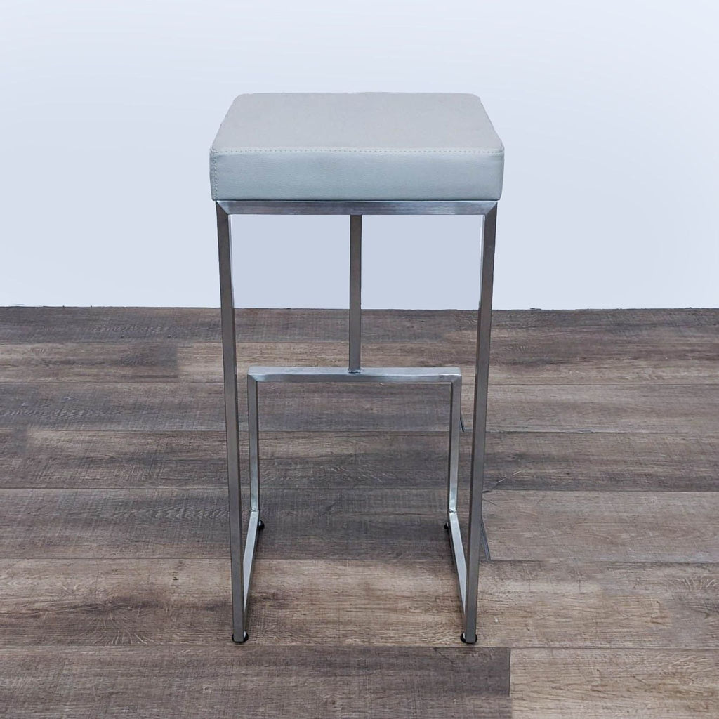 a pair of chromed stools by [ unused0 ] for [ unused0 ].