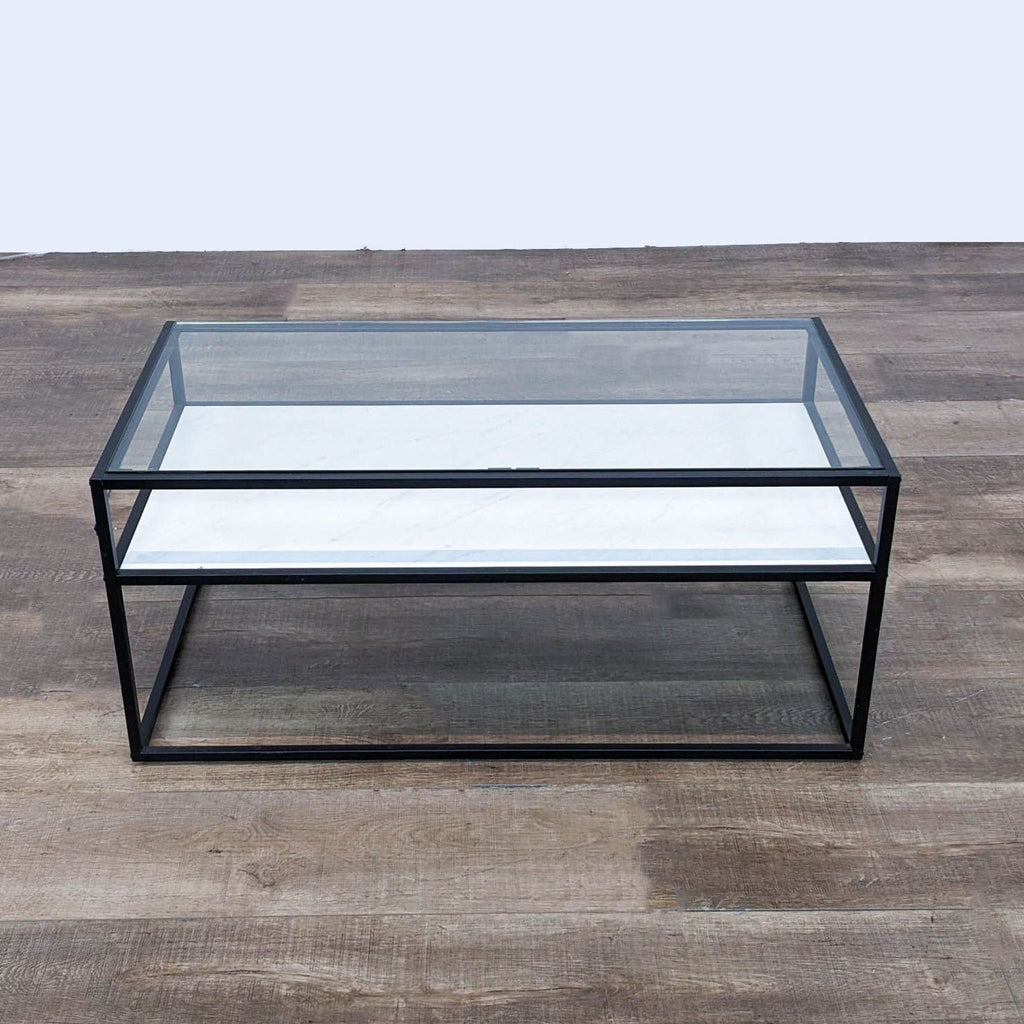 the glass top coffee table is a modern coffee table with a black metal frame.