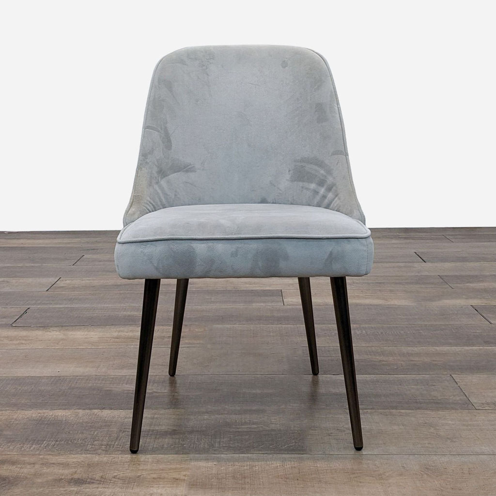 Front view of West Elm dining chair with upholstered seat and tapered legs.
