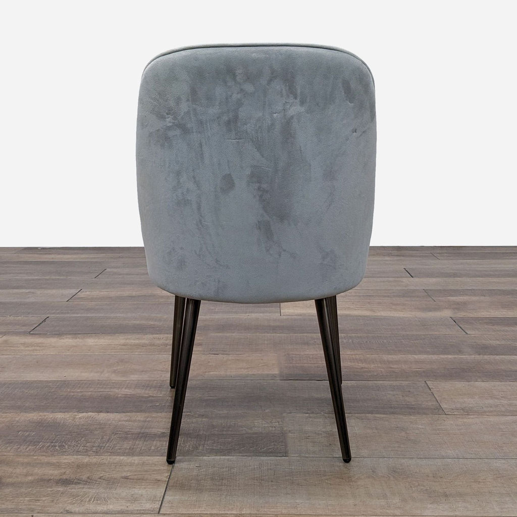 Back view of West Elm dining chair featuring minimalist design and tapered legs.