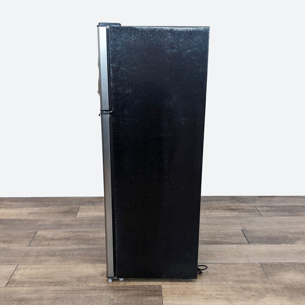 a vintage black and white refrigerator.