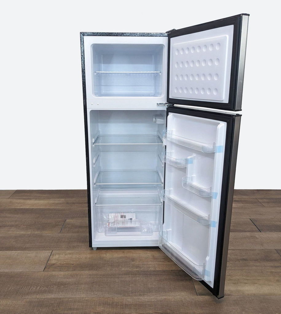 the fridge freezer is a compact refrigerator with a door open and a door open.