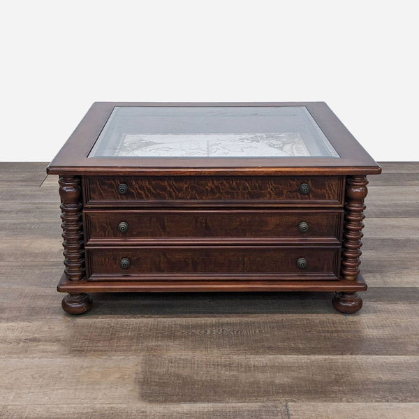 a 19th century mahogany chest of drawers with glass top.