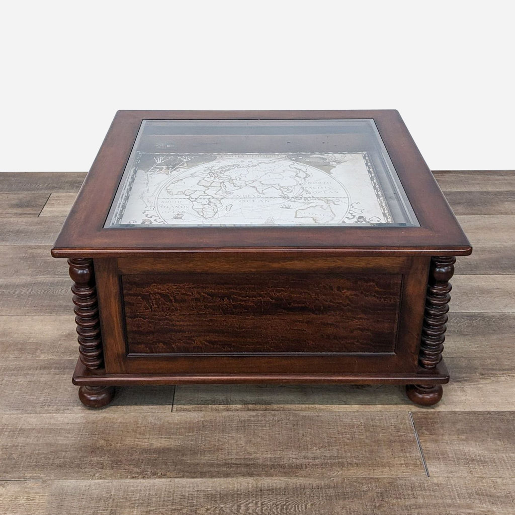 a vintage map table with a glass top.