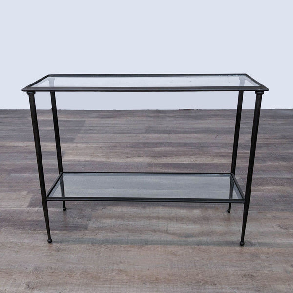 a black metal and glass console table with a glass shelf.