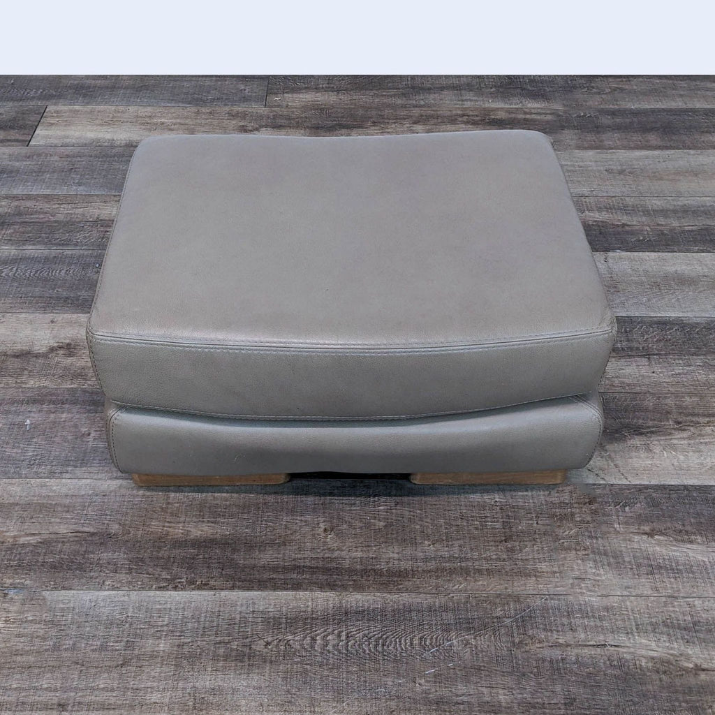the [ unused0 ] ottoman is a leather ottoman with a foot rest.