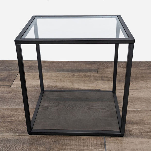 a black glass side table with a glass shelf.