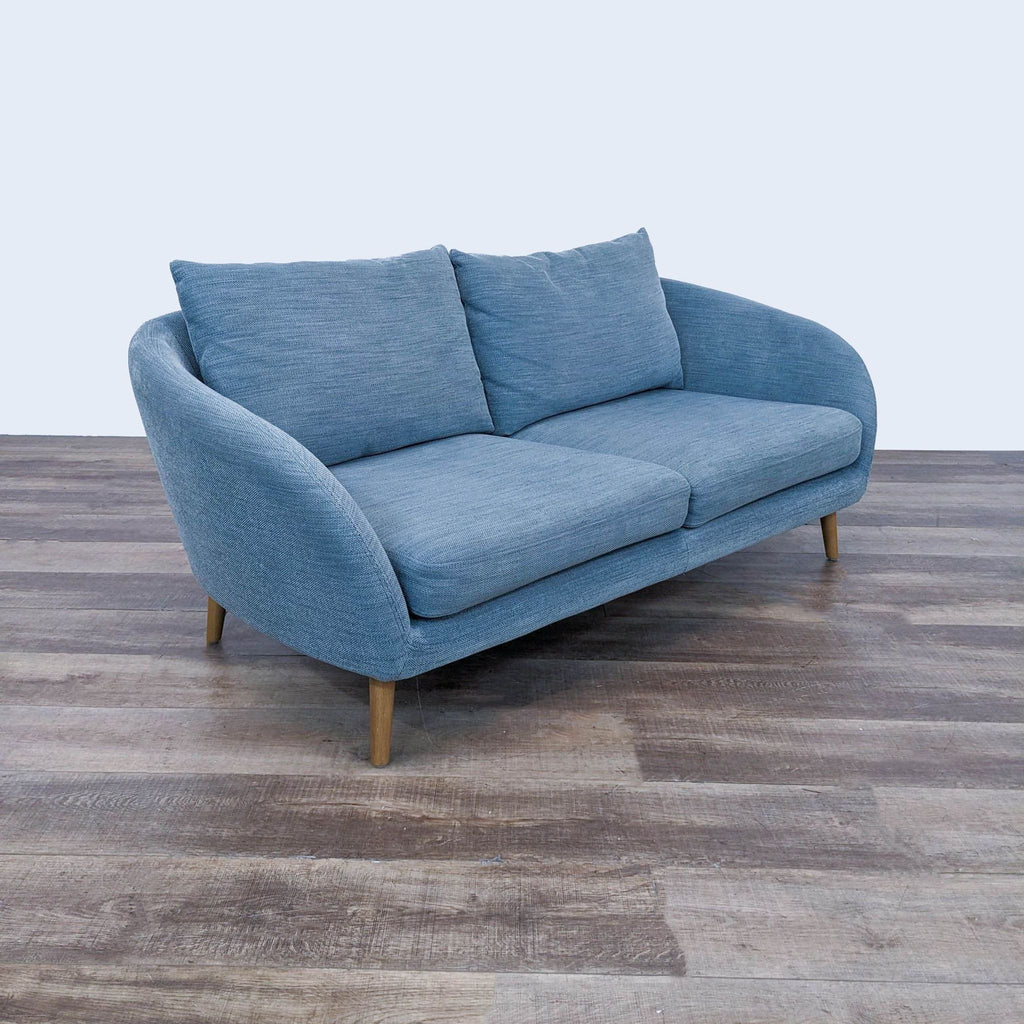 sofa is a modern sofa that is made of soft blue fabric. the sofa is made of soft
