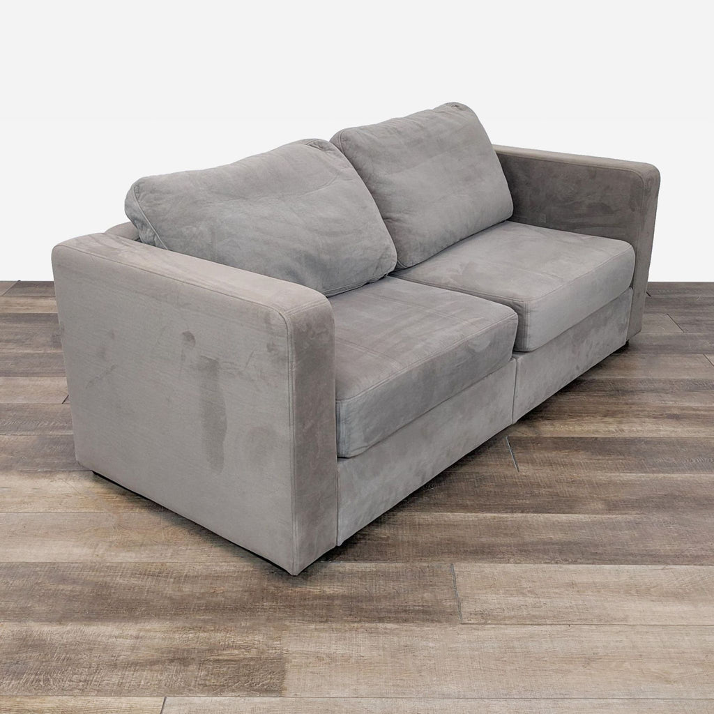 sofa in a grey color. this sofa is made of a soft grey color. the sofa is