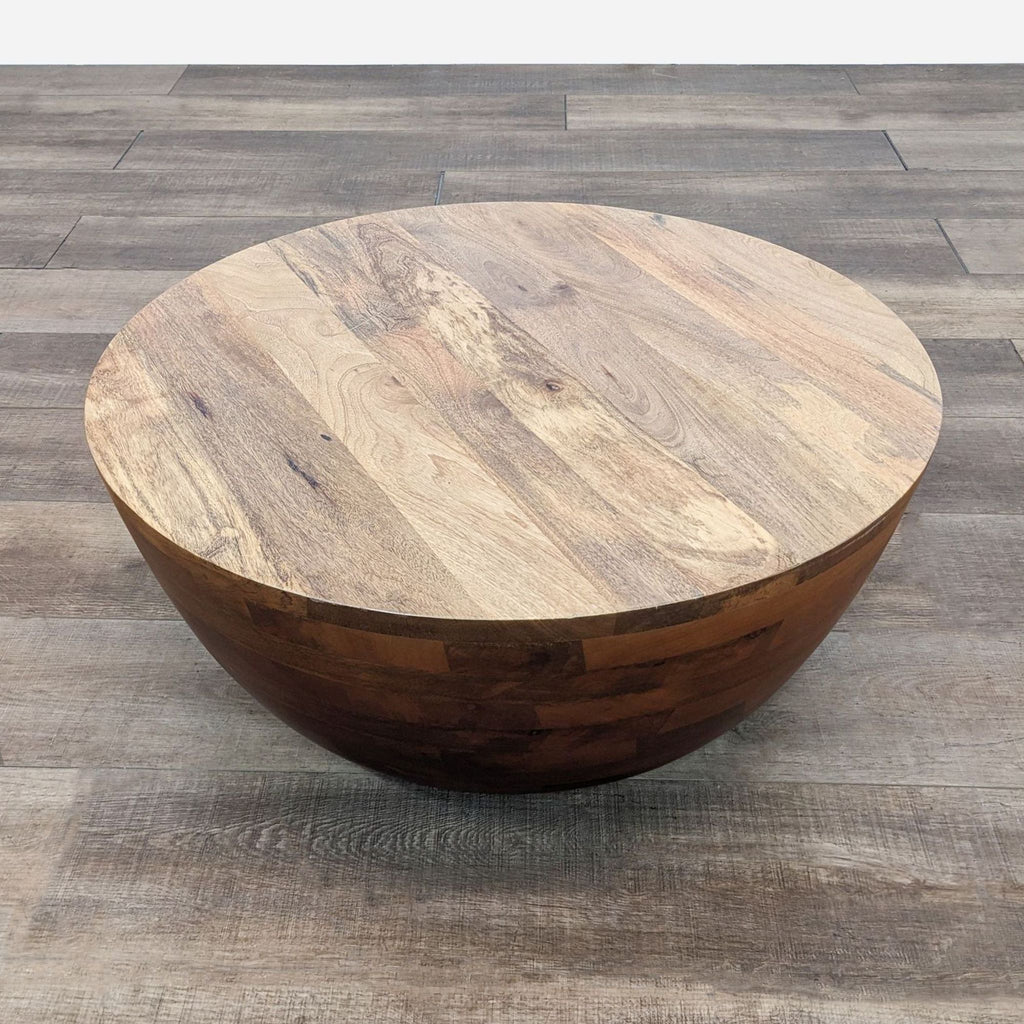 a round coffee table with a natural wood top.