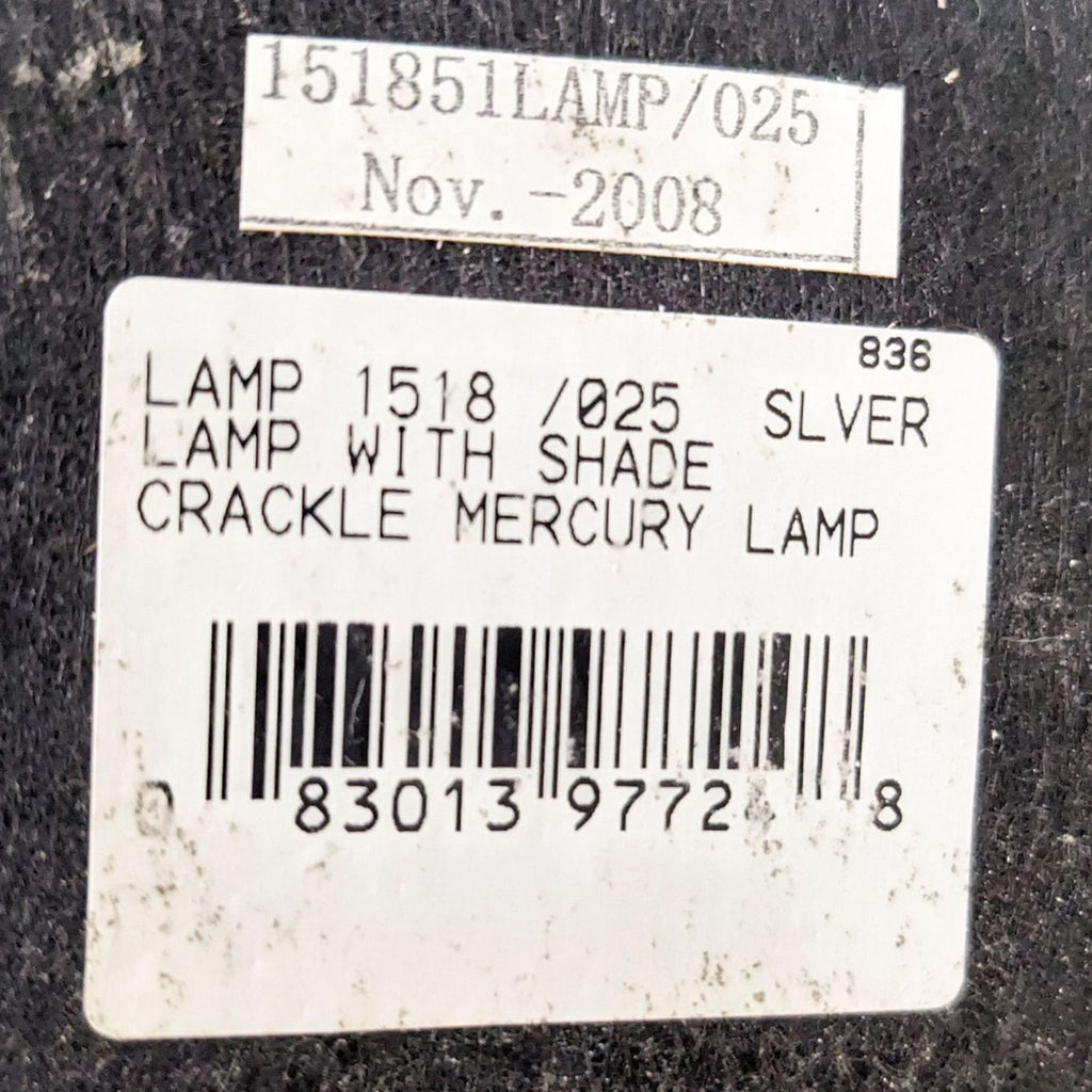 a label on a lamp with a silver crackle lamp.